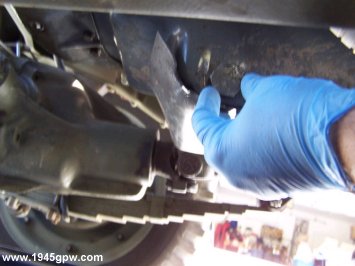 Twist the pan plug with your hand. Try not to drop the plug in the pan, and twist fairly quickly as the oil will start coming out, and depending on how warm your oil is, it can burn you.