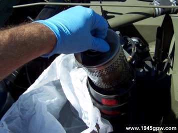 Here I will put a couple baggies from the grocery store to immediately transfer the old oil filter into it. Trying to avoid spilling oil all over the engine and ground.